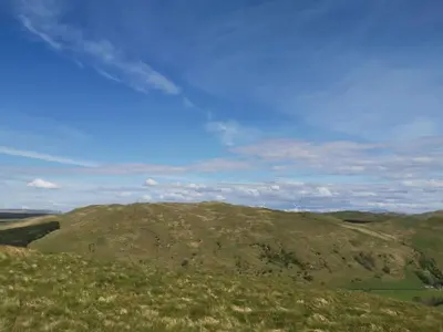 a view of a green hill with a blue sky at Balcraig House in Maybole