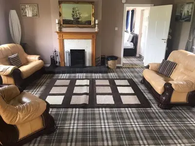 a living room with two couches and a fireplace at Cumnock Knowes Holiday Retreat in Carsphairn
