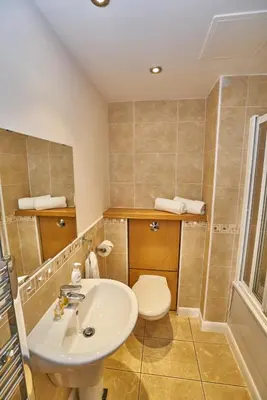 a bathroom with a sink and a toilet at Edinburgh Pearl Apartments - Fountainbridge Residence in Edinburgh