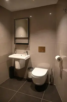 a bathroom with a toilet and a sink and a mirror at The Auld Kirk & Spa in Stirling