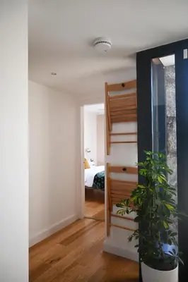 a room with a staircase and a bedroom with a bed at The Auld Kirk & Spa in Stirling