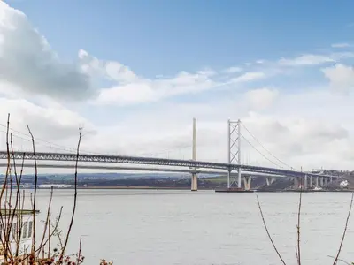 a large bridge over a river with water at Forth Reflections in Queensferry