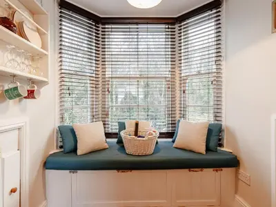 a window seat in a room with a large window at Forth Reflections in Queensferry