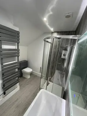 a bathroom with a shower and a sink and a toilet at Premier Studio B in Broxburn