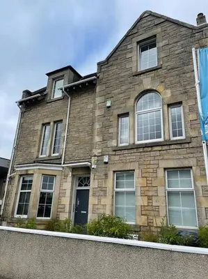 a large brick building with windows and a door at Premier Studio B in Broxburn