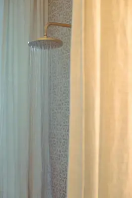 a bathroom with a shower with a shower curtain at Oakshaw Apartment in Paisley