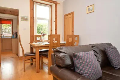 a living room with a couch and a table at Freeland Cottage in Dunoon