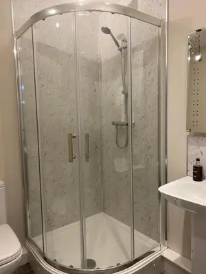 a shower with a glass door in a bathroom at The Inn At Charlestown in Dunfermline