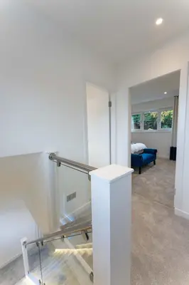 a room with a staircase and a blue couch at The Shore in Queensferry
