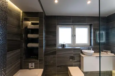 a bathroom with a sink and a glass shower at The Shore in Queensferry