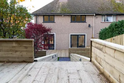 a house with a wooden fence in front of it at The Shore in Queensferry