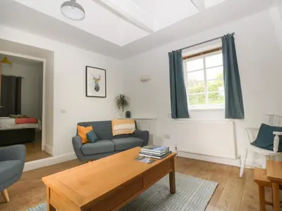 a living room with a couch and a table at Ellanderroch in Glasgow