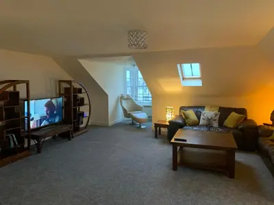 a living room with a couch and a tv at Ayr Loft Apartment with Fabulous Views in Ayr