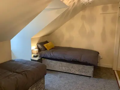 a room with two beds in the attic at Ayr Loft Apartment with Fabulous Views in Ayr