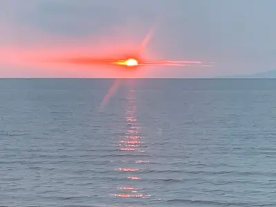 a reflection of the sun in the water at Ayr Loft Apartment with Fabulous Views in Ayr