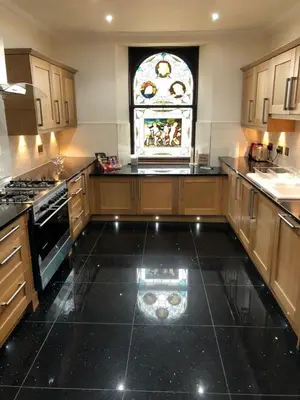 a kitchen with a black floor and a stained glass window at Beautiful 4-Bed Villa in Glasgow in Glasgow