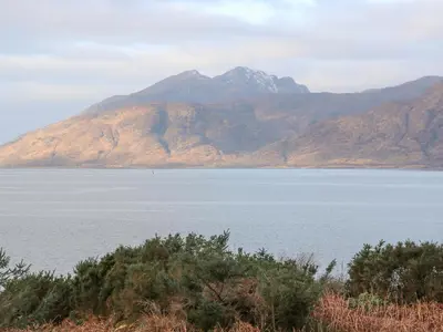 a large body of water with mountains in the background at Sea Otter Cottage in Appin
