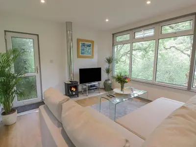 a living room with a couch and a table at The River Lodge in Oban