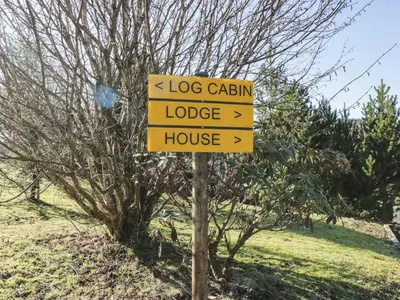 a sign that says dog cabin lodge and house at The River Lodge in Oban