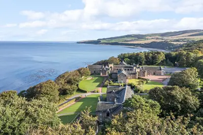 an aerial view of a mansion next to the water at Ardlochan Lodge - Culzean Castle in Maybole