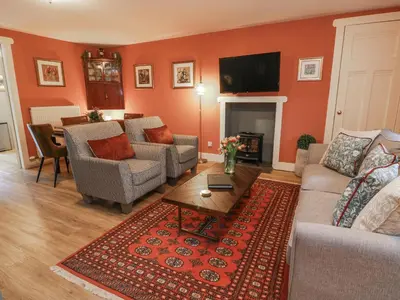 a living room with two couches and a table at The Coach House - Holmwood in Glasgow