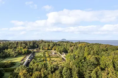 an aerial view of a park with trees and the ocean at North Segganwell - Culzean Castle in Maybole