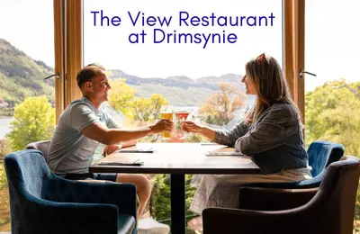 a man and woman sitting at a table drinking beer at Ben Arthur Place 6 - Sleep 6 in Lochgoilhead