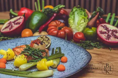 a plate of food with vegetables on a table at Broadcroft Hotel in Kirkintilloch