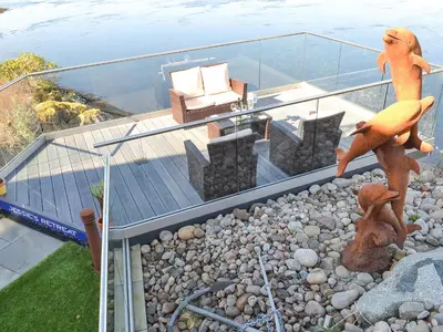 a house with a viewing deck with a couch on it at 4 Dolphins in Connel