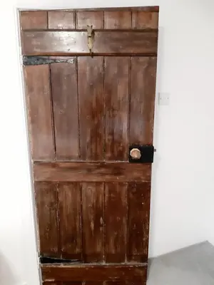 an old wooden door in the corner of a room at No 2 Planetree in Lochgoilhead