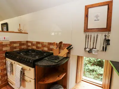 a kitchen with a stove and a window at The Steading in Dalmally