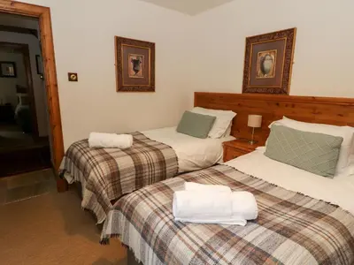 a bedroom with two beds with towels on them at The Steading in Dalmally