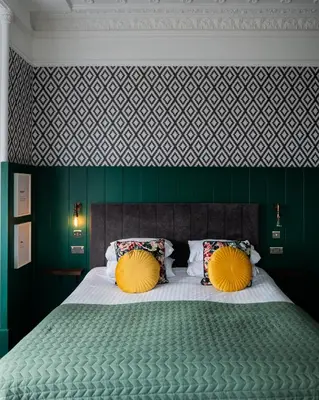 a bedroom with a large bed with two yellow pillows at Witchwood House in Oban