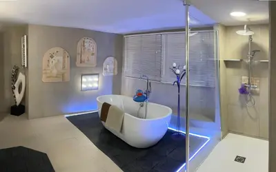 a bathroom with a bath tub and a shower at The Retreat Tranquil Countryside Apartment in Larkhall
