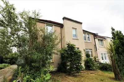 an apartment building with trees in front of it at Macintosh Upper in Bellshill