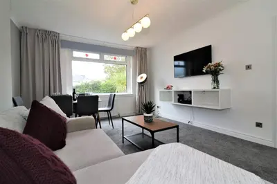a living room with a couch and a table at Macintosh lower in Bellshill