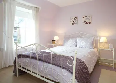 a bedroom with a bed and a window at Avonlea Self-Catering in Crieff