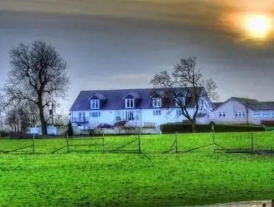 a large white house in a field of green grass at The Green Monkey Lux Suite at The Grumpy Schnauzer B&B Private Hot Tub, Gym, Breakfast, Stunning! in New Monkland