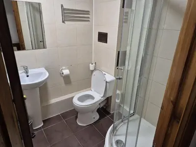 a bathroom with a toilet and a sink and a shower at Glasgow House in Glasgow