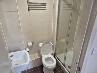a bathroom with a toilet and a sink and a shower at Glasgow House in Glasgow