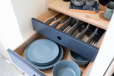 a drawer filled with blue plates and utensils at Cardross Estate Glamping Pods in Stirling