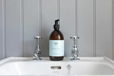 a bottle of wine sitting on top of a sink at Stableyard Apartment: Drumlanrig Castle in Thornhill