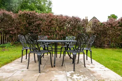 a group of chairs sitting around a table at Drumlanrig Mains Cottage in Thornhill