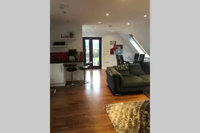 a living room with a couch and a desk at Private Coach house in gated residence in Stirling