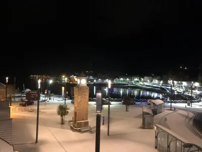 a clock tower in a parking lot at night at Seaside Apartment in Oban