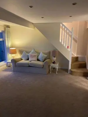 a living room with a couch and a staircase at 1 Bed House - Central Free Parking Wifi in Stirling