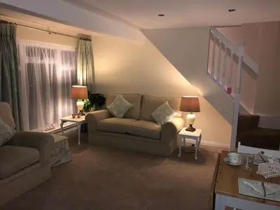 a living room with a couch and two tables at 1 Bed House - Central Free Parking Wifi in Stirling