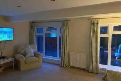 a living room with a chair and a window at 1 Bed House - Central Free Parking Wifi in Stirling