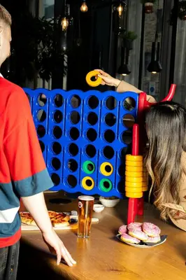 two people standing around a table playing with a toy at Moxy Edinburgh Fountainbridge in Edinburgh