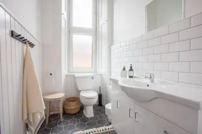 a white bathroom with a toilet and a sink at Stunning 2 bed property in heart of West End in Glasgow
